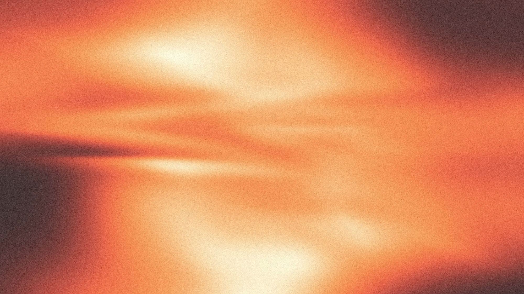 An abstract blur of orange and peach light